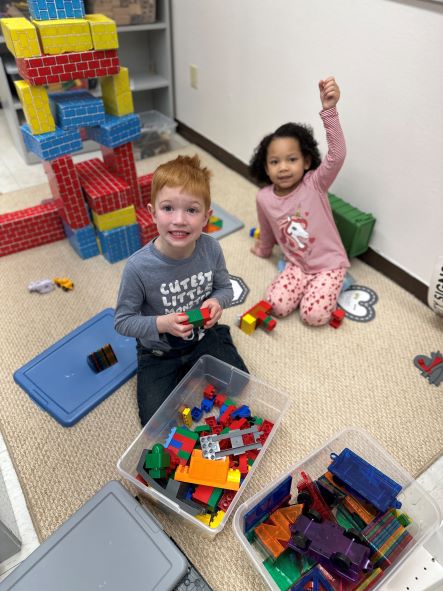 two students playing with blocks